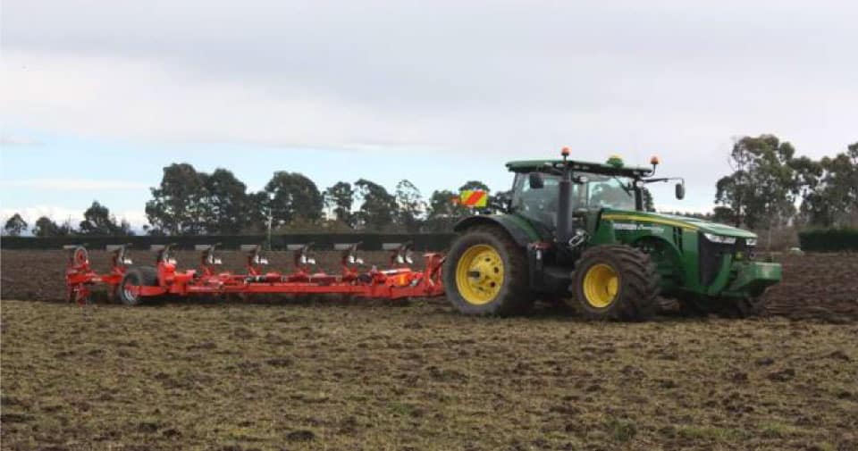 Newsletter-Kuhn Tractor with balage silage machine working along a paddock